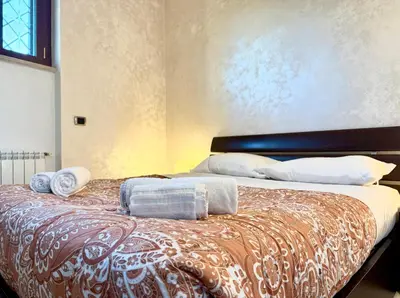 a bedroom with a bed with towels on it at Marconi Penthouse in Rome