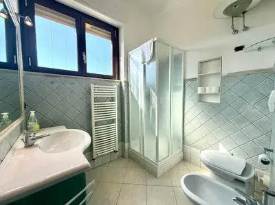 a bathroom with a sink and a shower at Marconi Penthouse in Rome