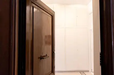 a wooden door in a room with a window at Colosseo Apartment - Domus Claudinae in Rome