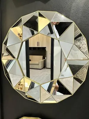 a mirror on a wall with a man taking a picture at lucky home in Trastevere in Rome