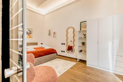 a bedroom with a bed and a guitar on the wall at Cozy Rome - Newly Renovated Apartment near Vatican City in Rome