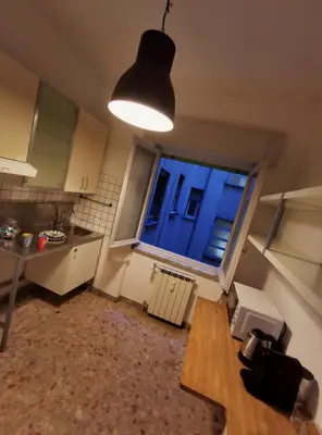 a kitchen with a window and a table and a light at Kea Alloggio Turistico in Rome