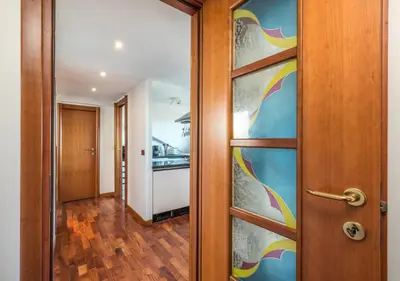 a door leading into a kitchen with a colorful wall at Vaticano-Metro A, Penthouse with AC, Wi-Fi e Netflix in Rome