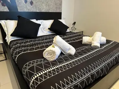 a bed with towels and pillows on it at Domus Symmetrie in Rome