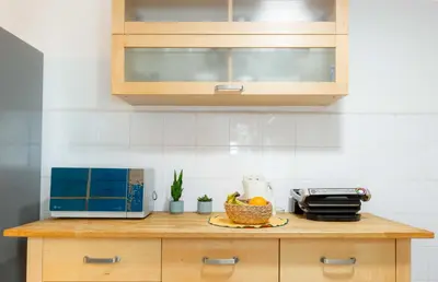 a kitchen counter with a microwave and a bowl of fruit at Casa Emiliani Ospedale San Camillo - Cale 09 in Rome