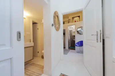 a hallway with a door leading to a bathroom at Beautiful Monti apartment Panisperna in Rome