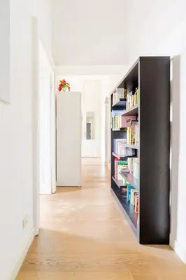 a room with a book shelf with books at Principe House, Central Rome, 3 bedroom 2 bath, Elegant Apartment full of Light in Rome