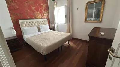 a bedroom with a bed and a table and a mirror at Cellini apartments in Rome