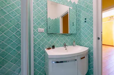 a bathroom with a sink and a mirror at Emanuele Filiberto - Vivora Srl in Rome