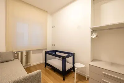 a small room with a bed and a chair at Floresa Vatican Elite in Rome