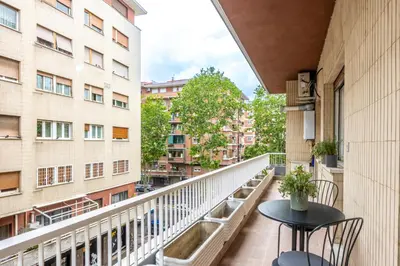 a balcony with a table and chairs and buildings at Floresa Vatican Elite in Rome