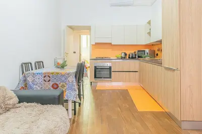 a kitchen with a table and a dining room at Home relax San Lorenzo in Rome