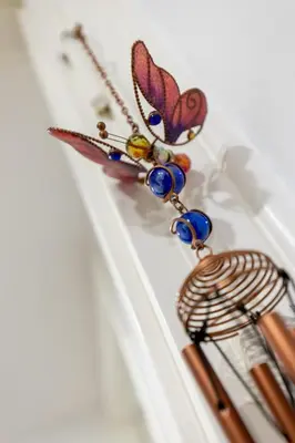 a pair of butterfly earrings on a shelf at Br1tannia 36 in Rome