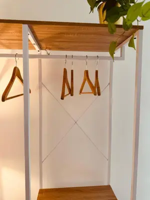 a white closet with wooden hangers and wooden shoes at Casa Umbertina in Rome