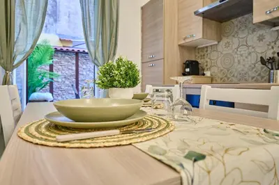 a table with a bowl and a plate on it at SweetgardenTrastevere in Rome