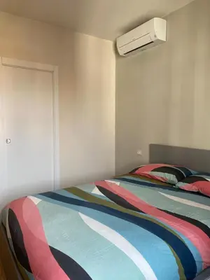 a bedroom with two beds and a white wall at Duck House Gemelli in Rome