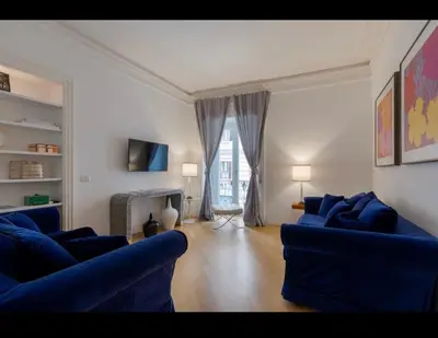 a living room with two blue couches and a fireplace at Rome Luxury House 5stars in Rome