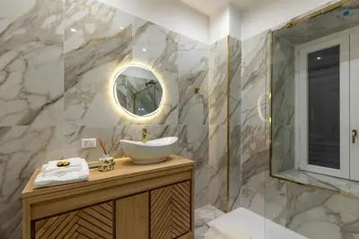 a bathroom with a sink and a mirror at Rome Luxury House 5stars in Rome