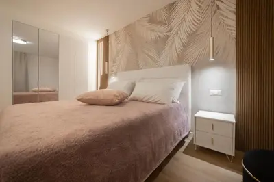 a bedroom with a large bed and a mirror at Vivi Roma in Rome