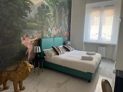 a bedroom with a bed with a painting on the wall at Roma Palace Suite in Rome