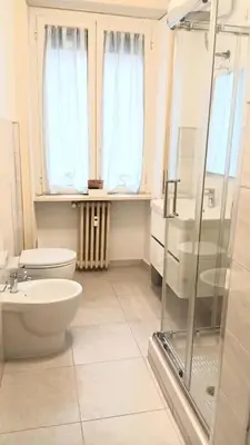 a bathroom with a toilet and a sink and a shower at BIBI San Giovanni Roma in Rome