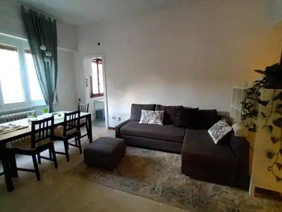 a living room with a couch and a table at Casa verde di Mia in Rome
