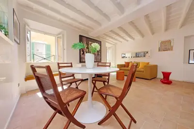 a living room with a table and chairs at Colosseo nei Fori Imperiali by Luxury Getaways in Rome