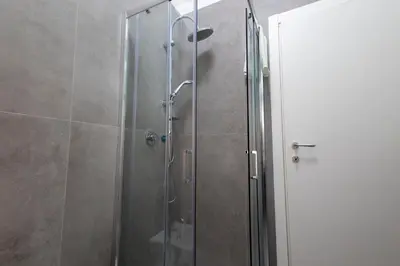 a shower with a glass door in a bathroom at Roma 2 minuti a piedi dal Vaticano in Rome