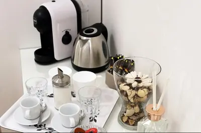 a table with cups and cups and a coffee maker at House 5 minutes walk from Vatican Museums in Rome