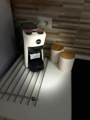 a coffee maker sitting on top of a refrigerator at La casa di Tilde Roma POLDO in Rome