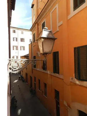 an alley with a street light on the side of a building at Vicolo del Lupo Guesthouse in Rome
