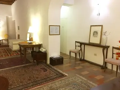 a living room filled with furniture and a table at Vicolo del Lupo Guesthouse in Rome