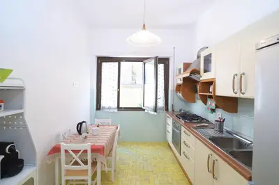 a kitchen with a table and a dining room at Roma San Pietro - L'Angolo di Marley apt in Rome