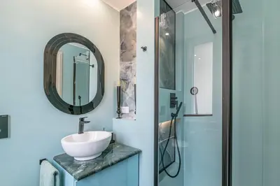 a bathroom with a sink and a mirror at Tu chiamale emozioni 3 suite in Rome