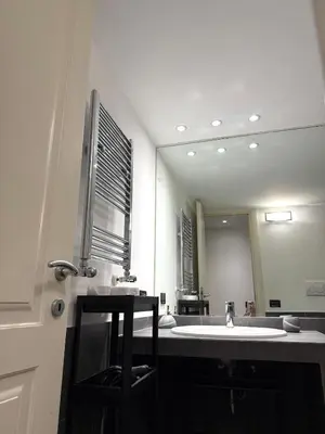 a bathroom with a sink and a large mirror at Loft in old town near Termini Station and University in Rome