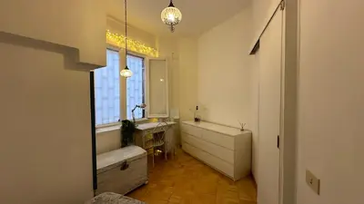 a bathroom with a tub and a sink and a window at The attic in Rome