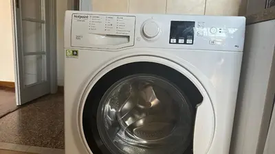a white washing machine sitting in a room at The attic in Rome