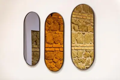 three skateboards on a wall next to a brick wall at Giulia Apartment in Rome