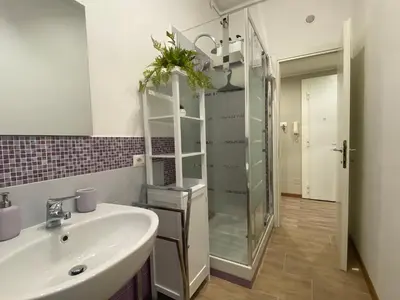 a bathroom with a sink and a shower at Papa's House - Re di Roma in Rome