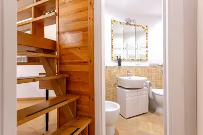 a bathroom with a toilet and a sink at Oliviero - Colosseo Apartment with Terrace in Rome