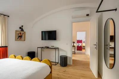 a bedroom with a bed and a mirror at Daplace - Costanza Apartment in Rome