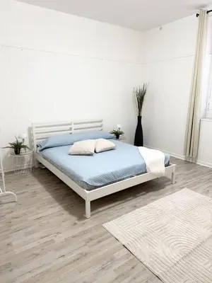 a bedroom with a bed in a white room at VOLUPTA' S HOUSE in Rome MANZONI - COLOSSEO in Rome