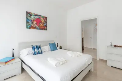 a bedroom with a white bed with towels on it at Lacasadigió in Rome
