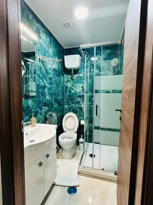 a bathroom with a toilet and a glass shower at Viktoria House Rome in Rome