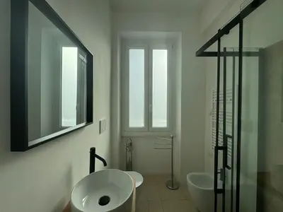 a white bathroom with a sink and a mirror at Stylish & Trendy Hub in Rome in Rome