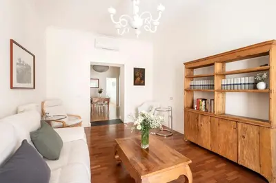 a living room with a white couch and a table at Trastevere Penthouse in Rome