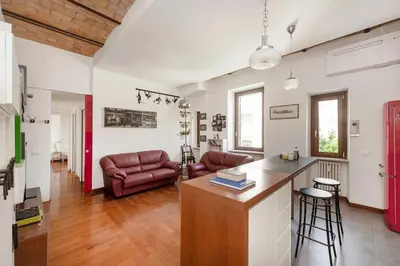 a kitchen and living room with a couch and a table at Hip Pad in Garbatella in Rome