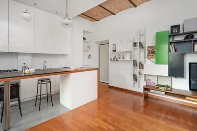 a kitchen with white cabinets and a counter top at Hip Pad in Garbatella in Rome