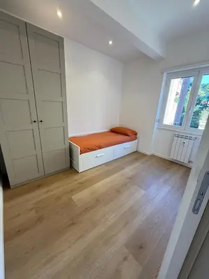 an empty room with a bed and a window at Appartamento in Rome