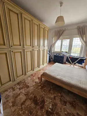 a room with a bed and some wooden cabinets at CS Banco Apartment in Rome